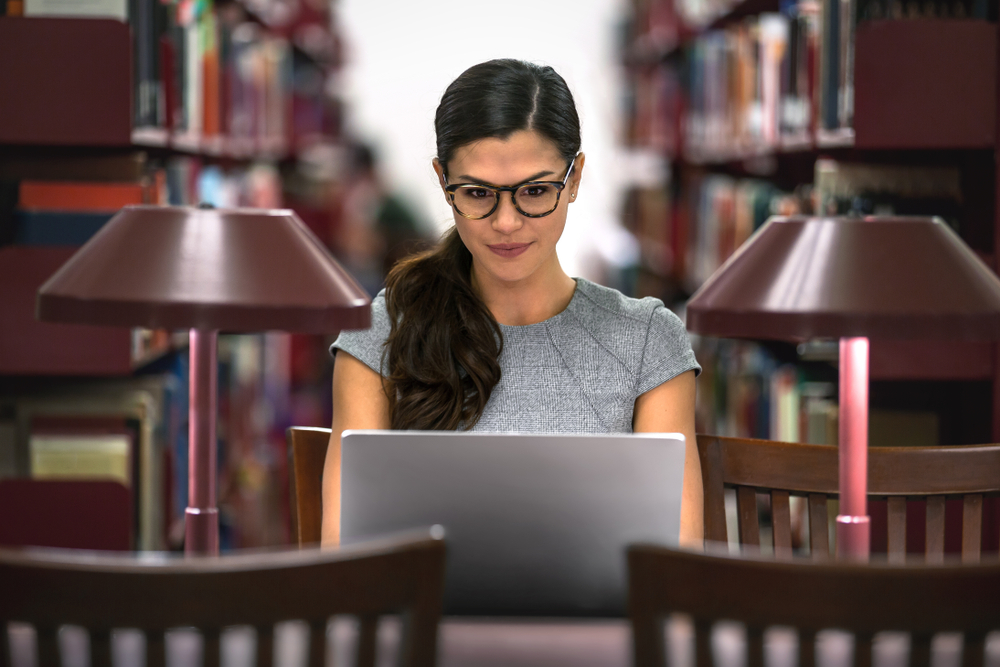 University student, degree in business, law, studying in library, determined to be successful