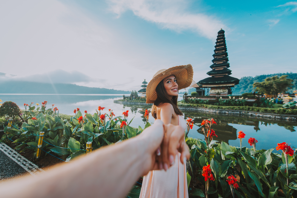 Couple spending time at the ulun datu bratan temple in Bali. Concept about exotic lifestyle wanderlust traveling