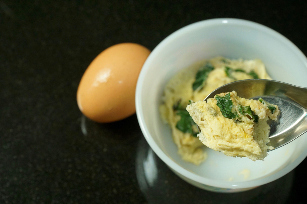 Omelette (Omelet) with basil and little soy sauce. Cooking from microwave. Quick and easy to cook. Copy space.