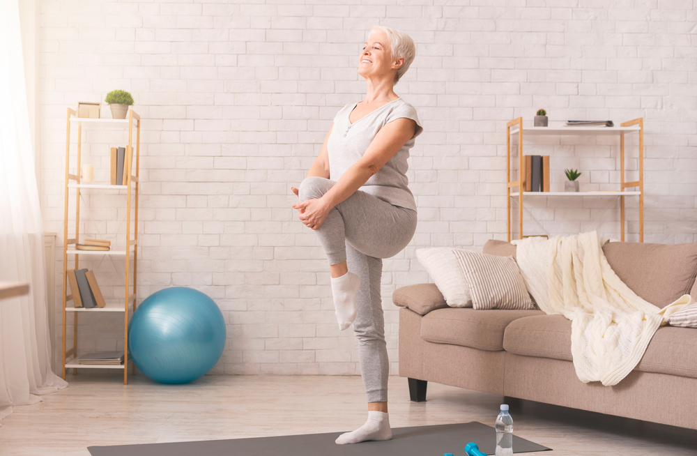 Overjoyed mature grey-haired Caucasian husband and wife have fun enjoy time together at home, happy elderly couple spouses dancing in living room, senior man lead sway smiling middle-aged woman