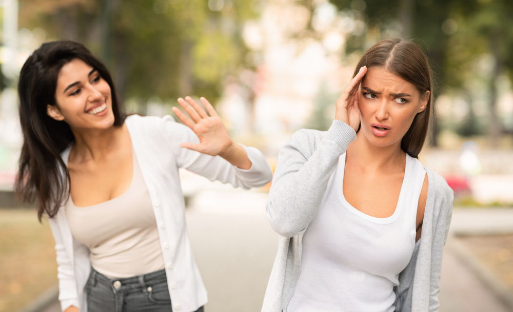 Girl Avoiding Meeting Toxic Friend Girl Ignoring Her Greeting Walking In Park Outdoors. Selective Focus
