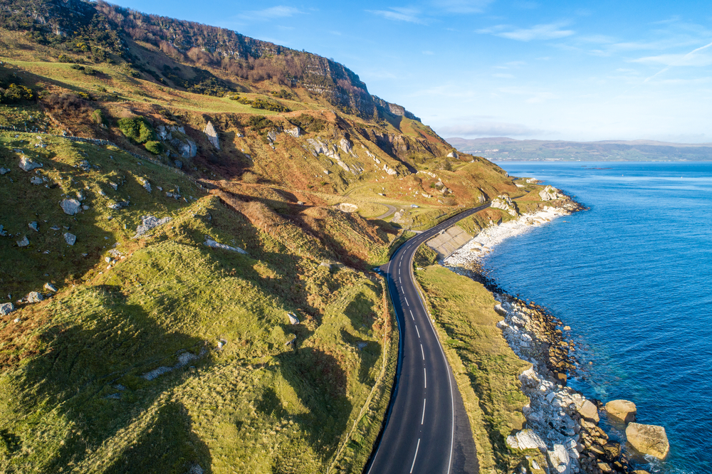 The eastern coast of Northern Ireland and Causeway Coastal Route a.k.a Antrim Coast Road A2. One of the most scenic coastal roads in Europe. Aerial view in winter