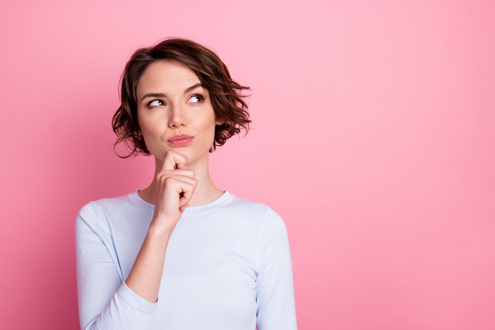 Focused smart girl look copyspace touch hand chin think decide wear pullover isolated pastel color background