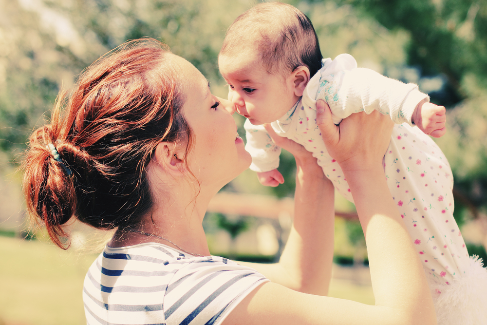 Portrait of happy loving mother and her baby outdoors