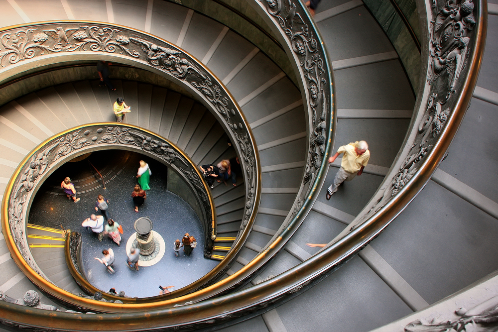 VATICAN - AUGUST 4: Unidentified people go down spiral stairs in Vatican Museums on August 4, 2011 in Vatican. Vatican City is the smallest internationally recognized independent state in the world.
