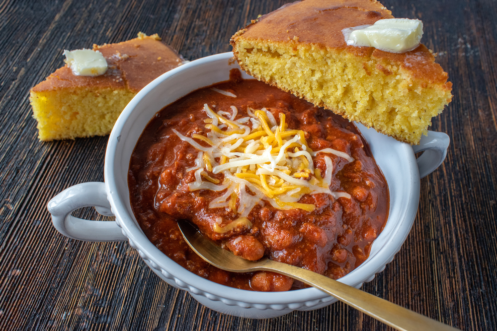 closeup of bowl of homemade chili with cornbread