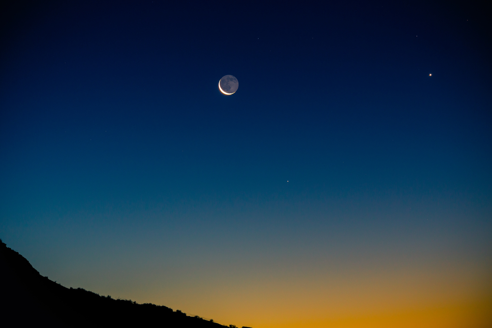 Crescent moon with earthshine and Venus rise with the mornings twilight in the desert..