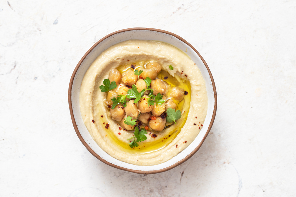 Classic hummus with parsley on a plate . Traditional hummus salad
