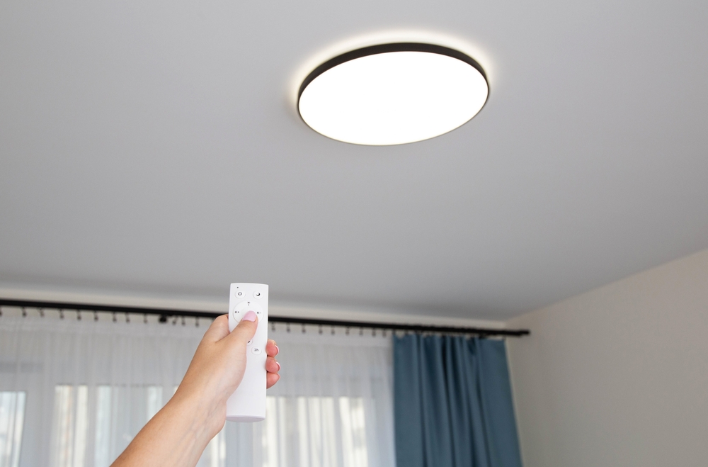Modern LED ceiling chandelier with on off control panel. Adjusting the brightness of the lighting in the room