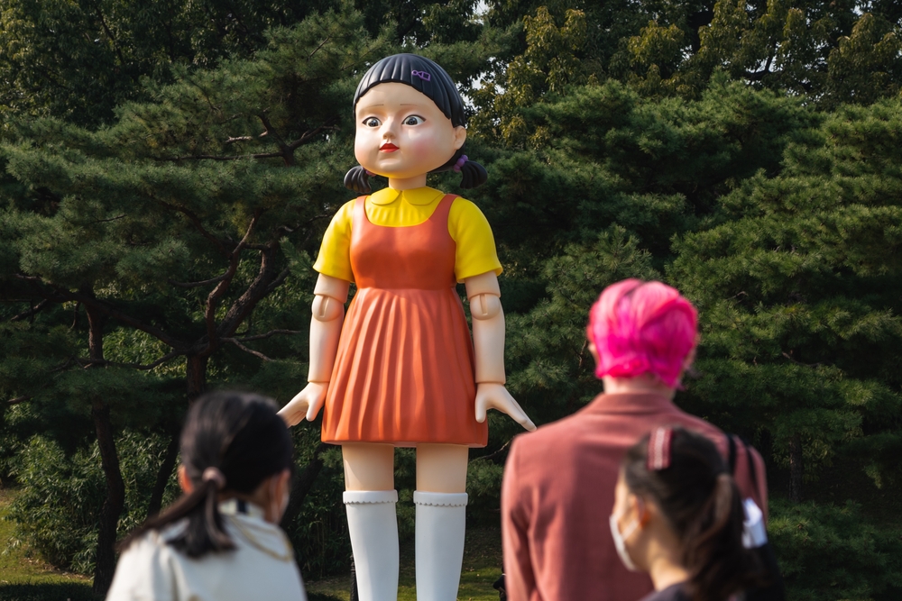 People take photos of the giant doll from Netflix original series 'Squid Game' at the Olympic Park in Seoul, South Korea, on Oct 26, 2021.