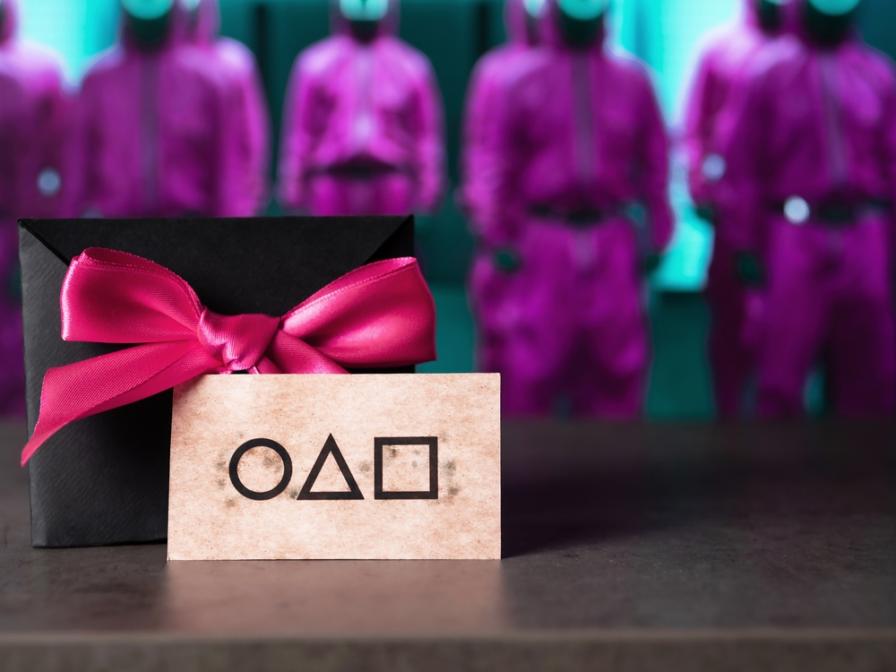 Stary Oskol, Belgorod Region, Russia - October 31, 2021: A business card based on the famous Korean Squid Game. An invitation on the background of the guards from the Squid Game.