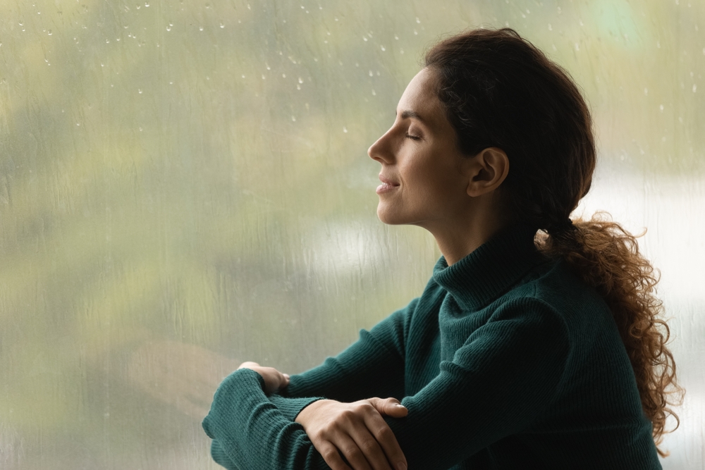 woman looking out window