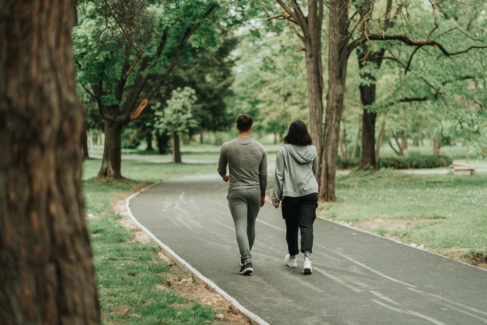 Sport couple walking on the path in the park