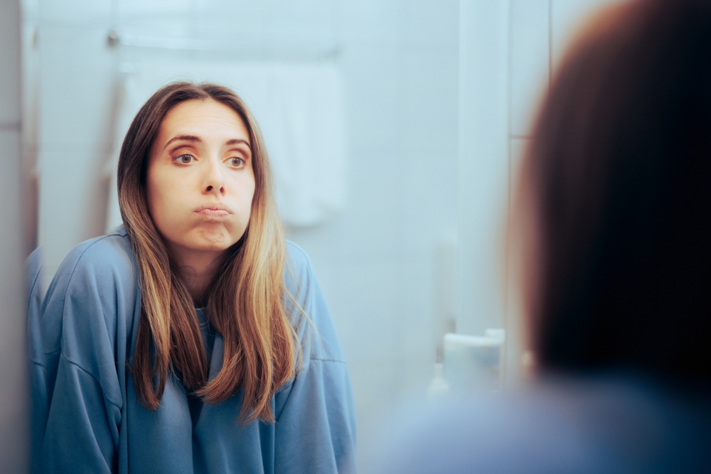 woman looking in mirror