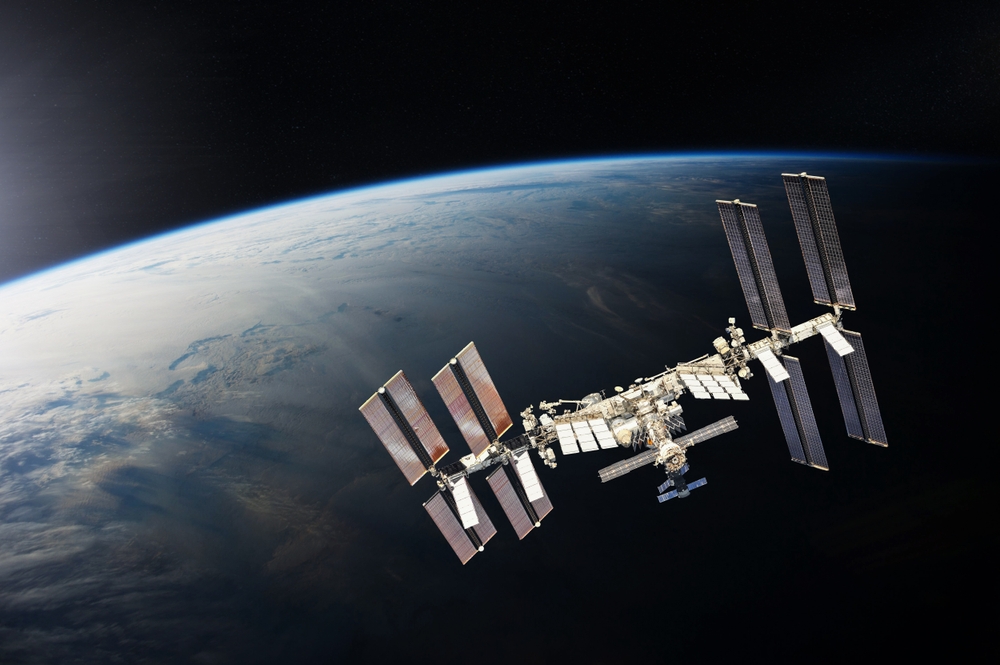ISS over the planet Earth. Elements of this image furnished by NASA.