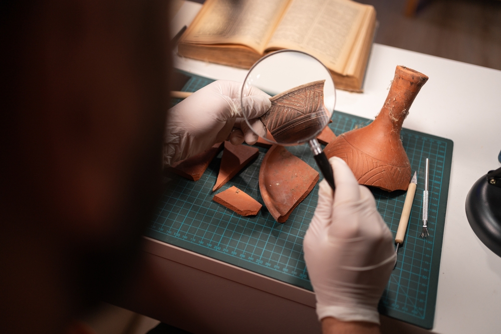 archaeologist examining pottery