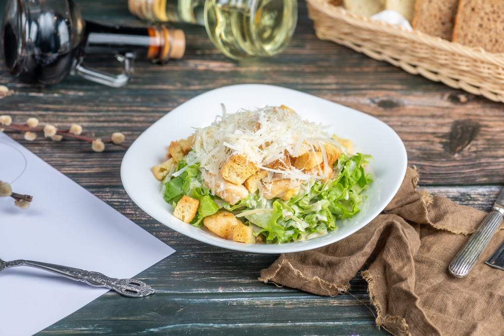 Caesar salad: A classic salad made with crisp romaine lettuce, croutons, Parmesan cheese, and a creamy Caesar dressing, often topped with grilled chicken or shrimp for added protein.