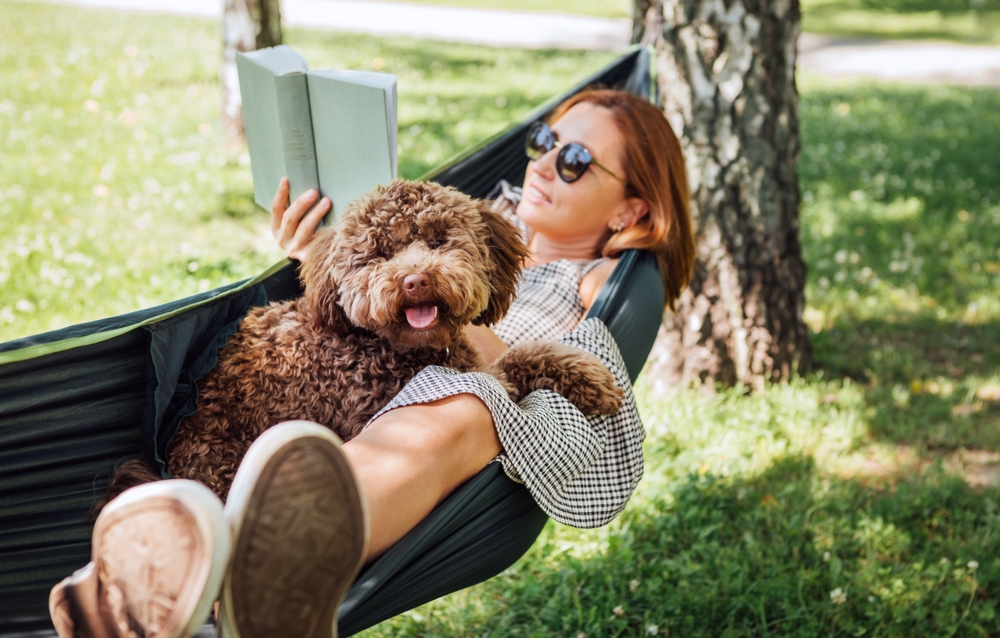 woman reading book in hammock