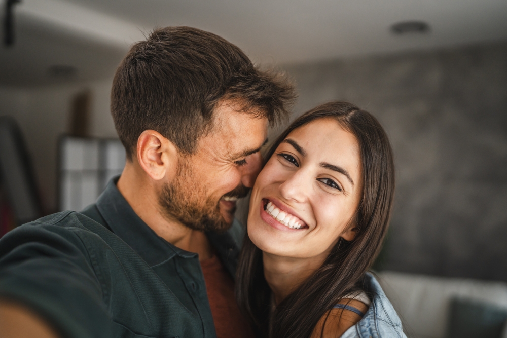 Self portrait of happy couple hug and have fun at home