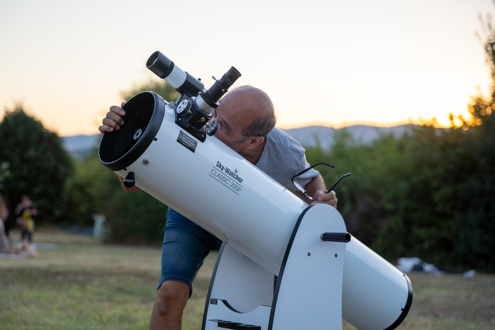 Saint Genis Laval, France - 9th of August 2024: A hobbyits astronomer looking through the telescope.