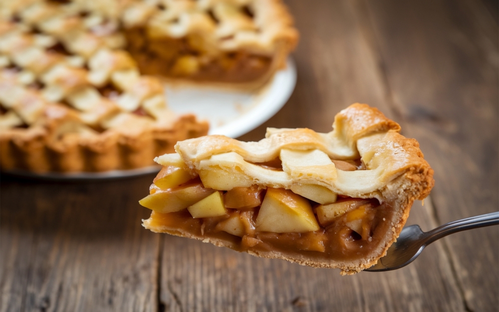 Apple Pie: A baked dessert with spiced apple filling, encased in a flaky, buttery crust, and often served warm with ice cream for a quintessentially American treat.