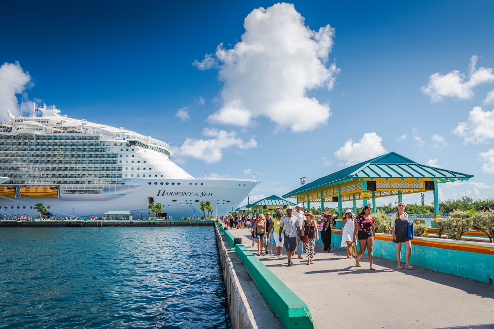 Nassau, Bahamas - August 19, 2018: Tourists deboarding Royal Caribbean Mariner of the Seas cruise ship docked in Nassau Cruise Port.