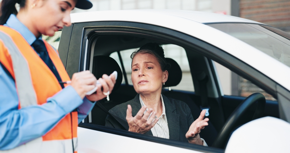 Woman, police and writing fine for car speeding, ticket warning and law violation of crime. Mature person, confused and officer with vehicle stop of penalty fee, bad driving and and question payment