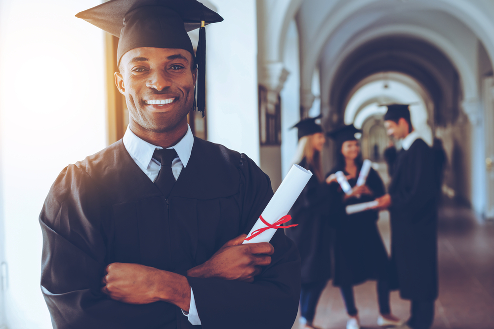 Happy graduate. Happy African man in graduation gown
