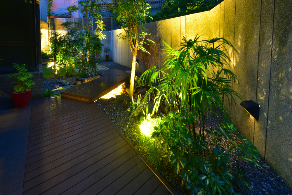 Walkway decorated with potted trees, walls, a sense of design in the golden light, like a small garden.