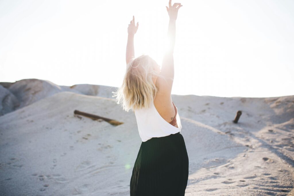 woman standing on sand dune