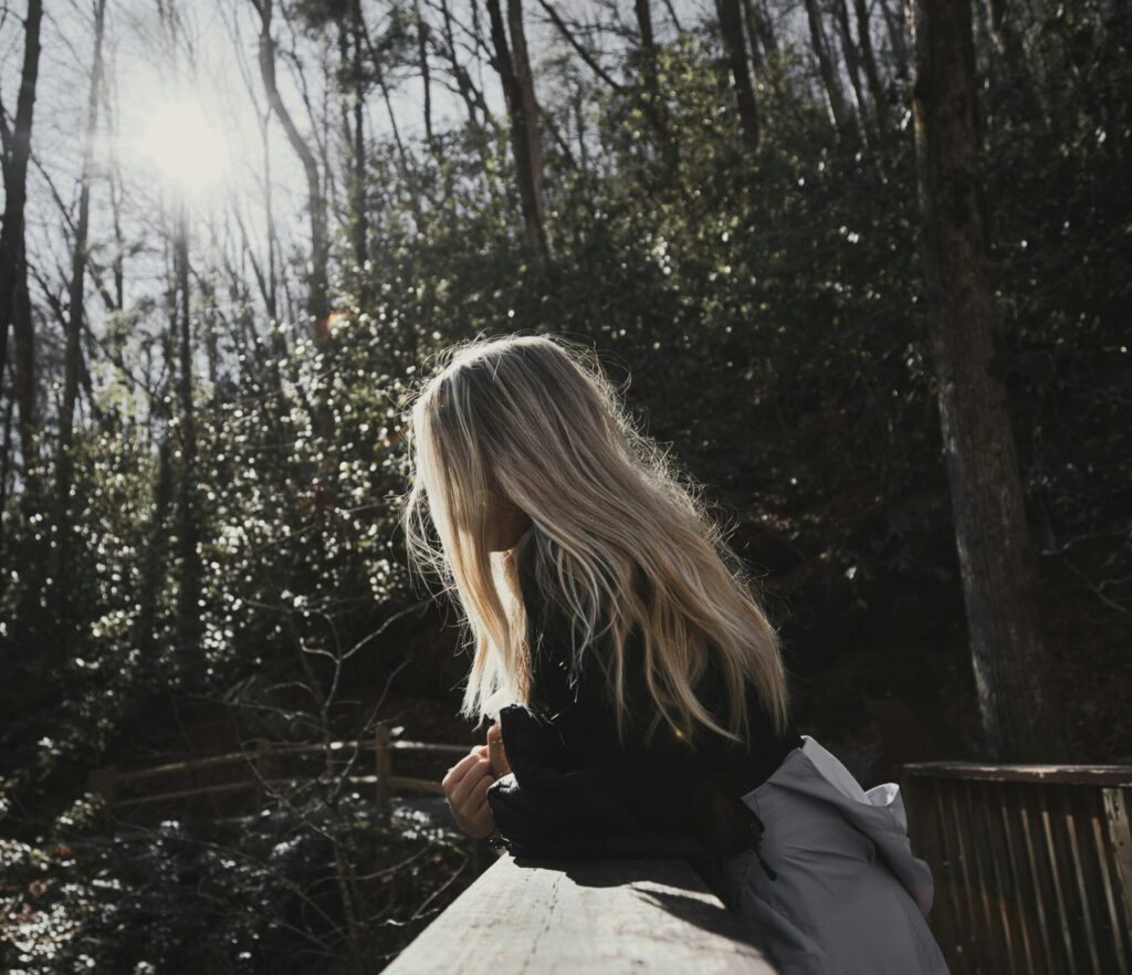 woman looking over bridge