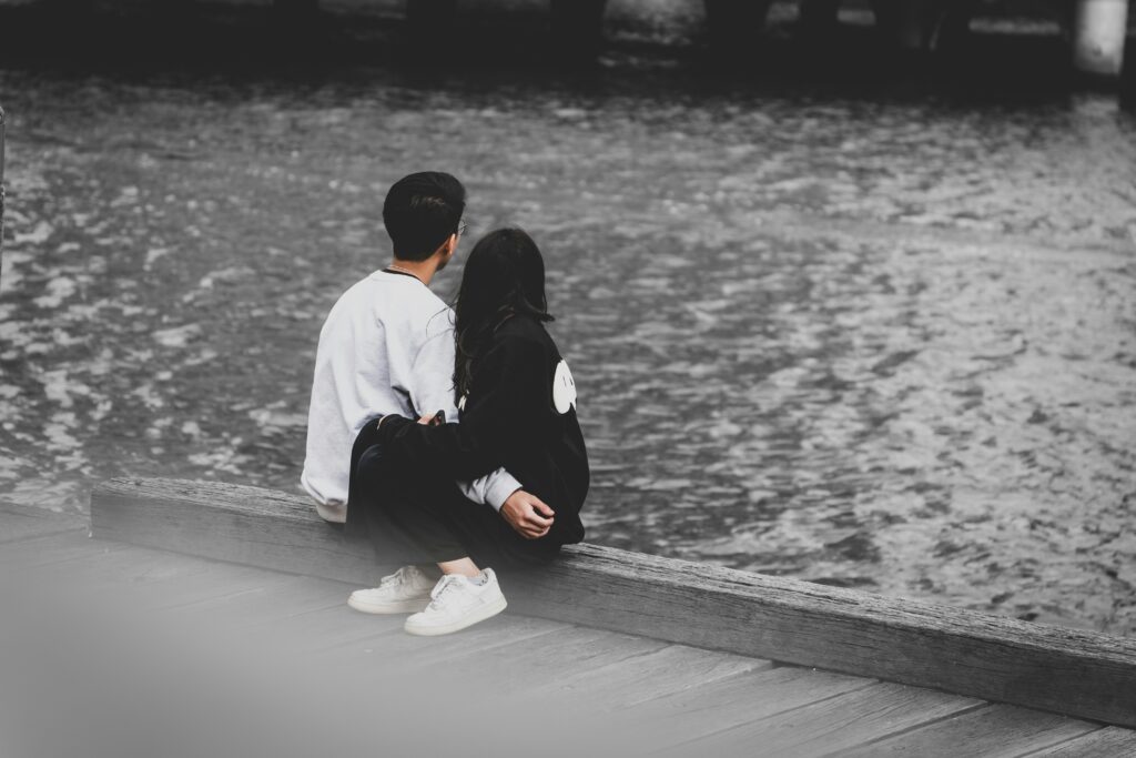 couple sitting near water