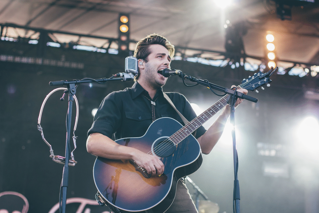 Image of Lord Huron sining on stage