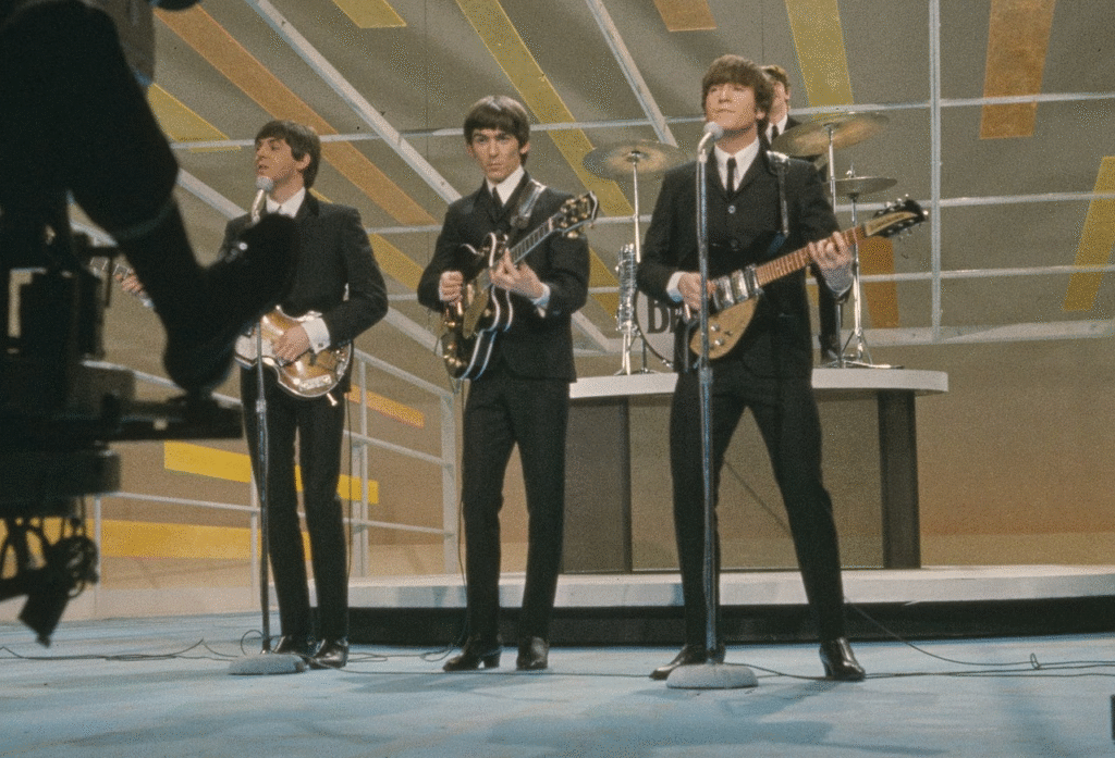 The Beatles singing on stage