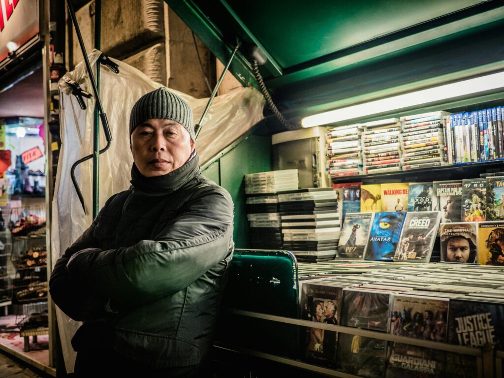 asian man outside dvd shop