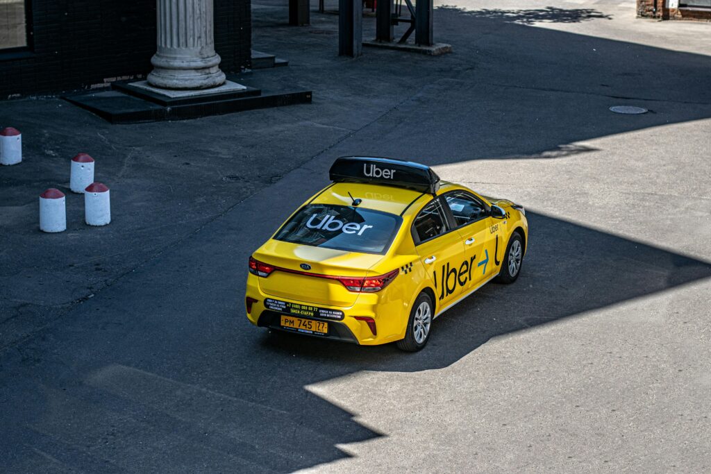 Yellow Uber Taxi on Urban Street
