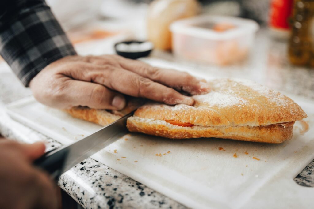 man cutting bread