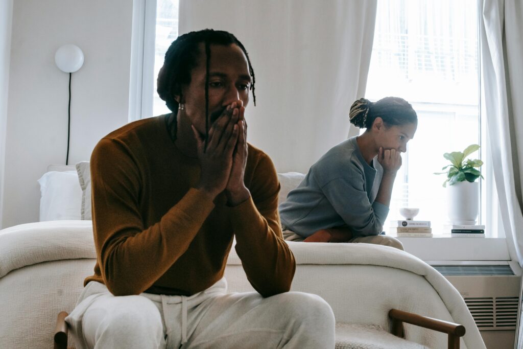 angry couple sitting on bed