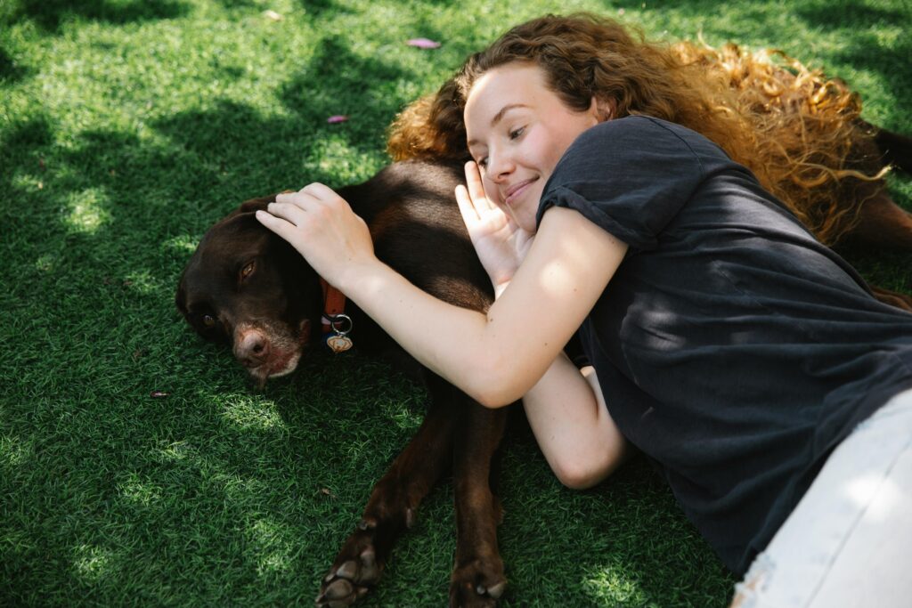 woman on grass with dog