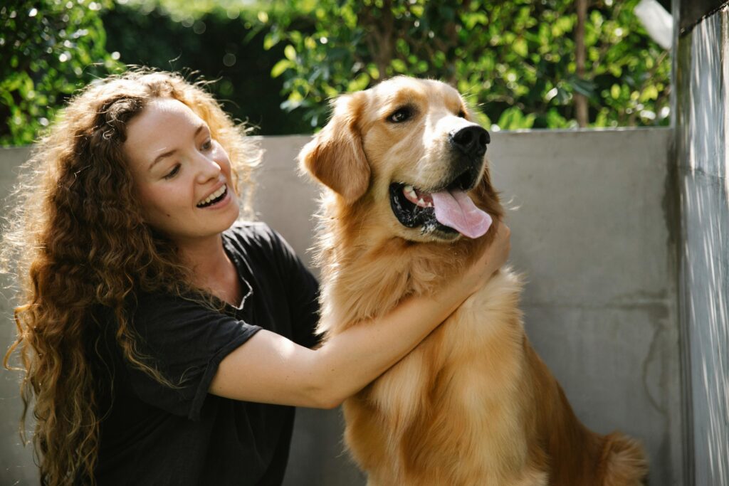 woman holing dog outside
