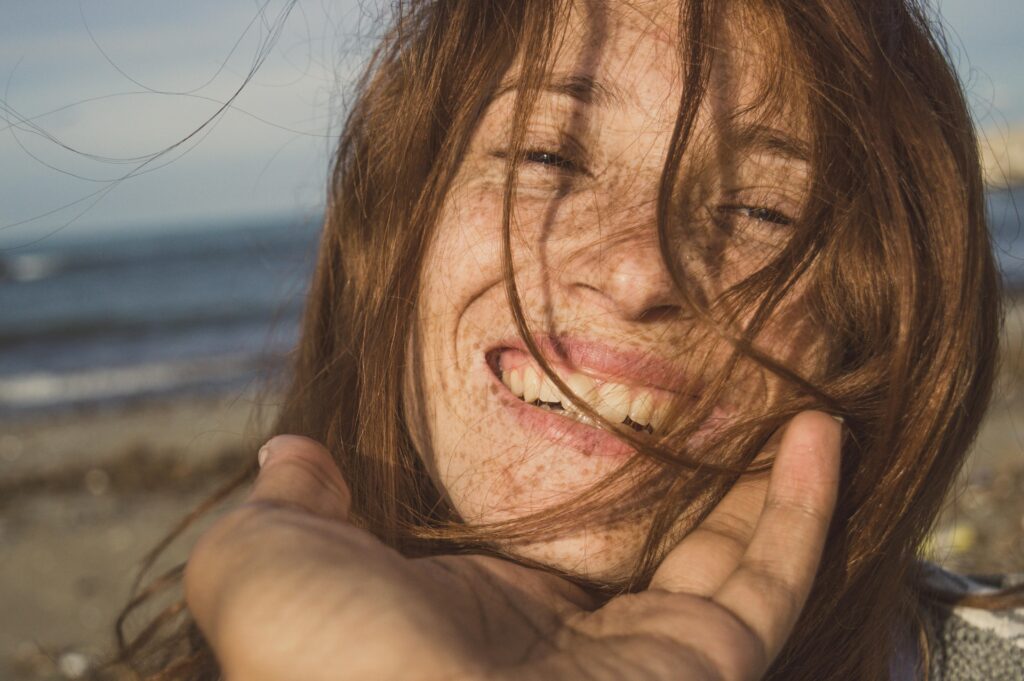 woman with freckles smiling 