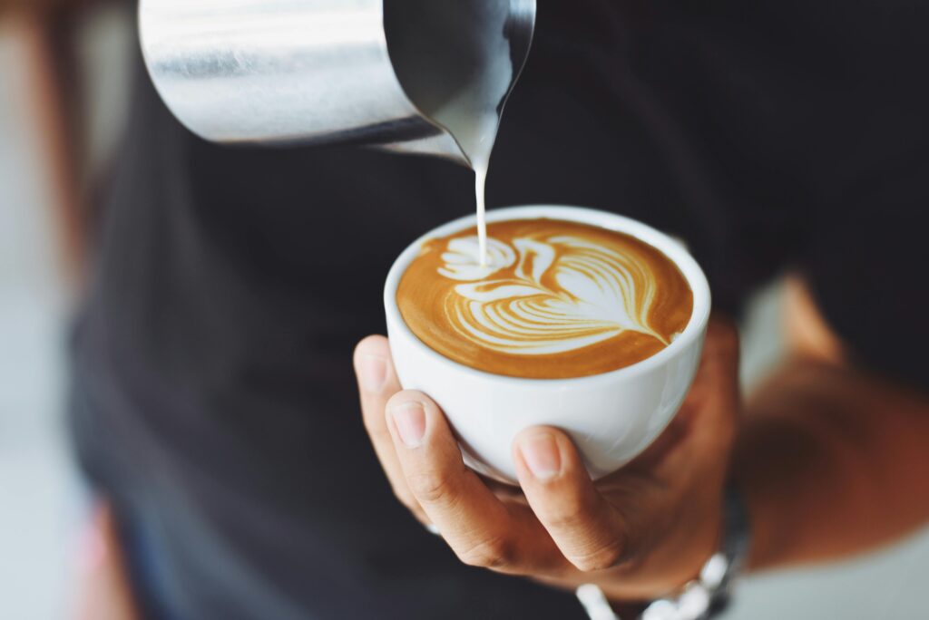 barista pouring coffee