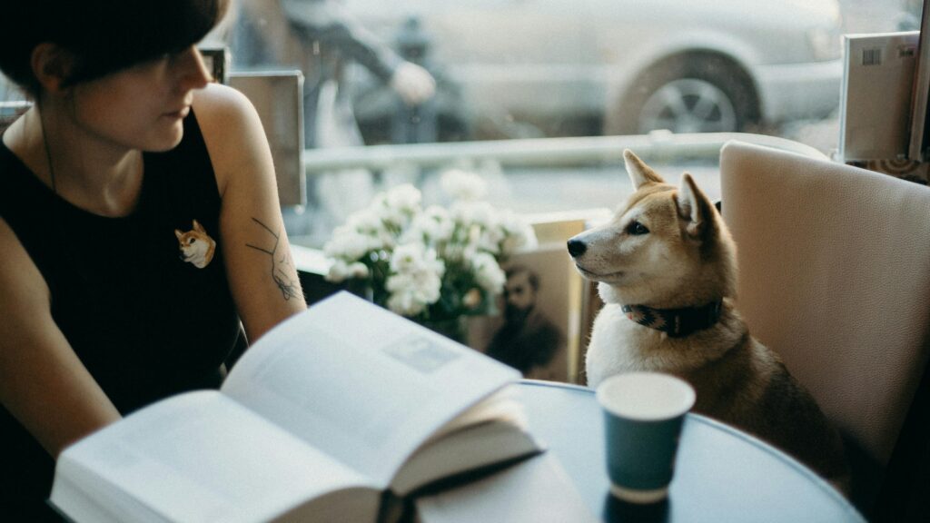 woman and dog sitting at chair