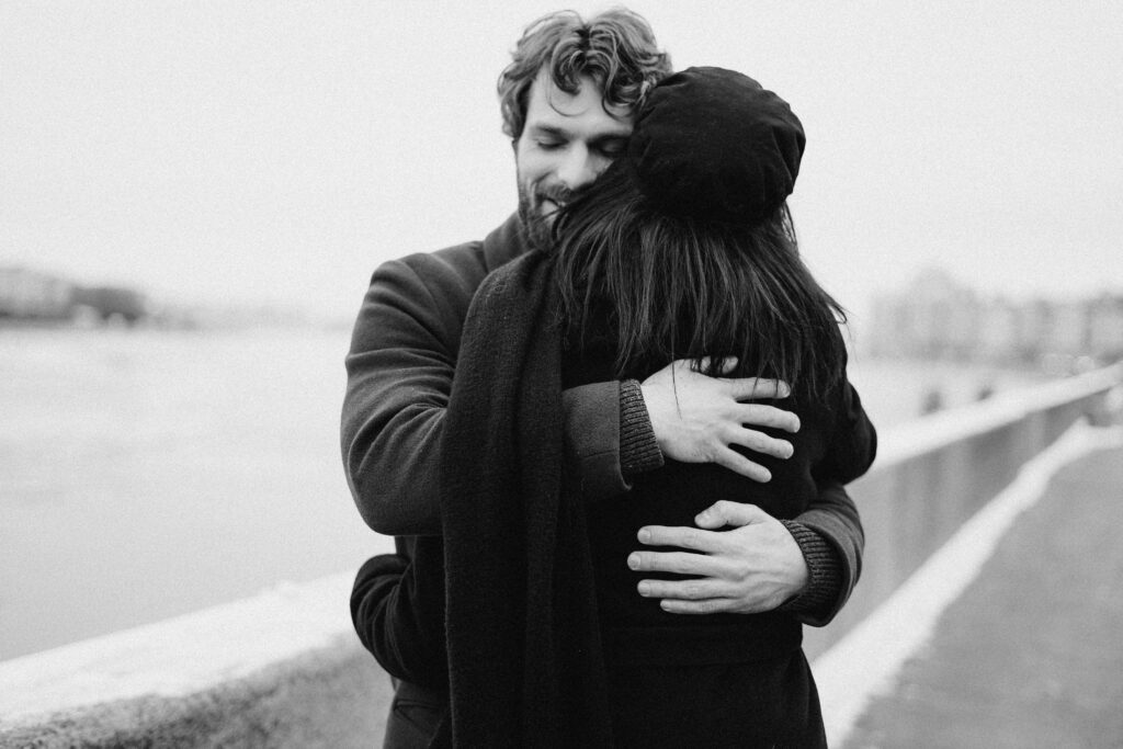 man hugging woman