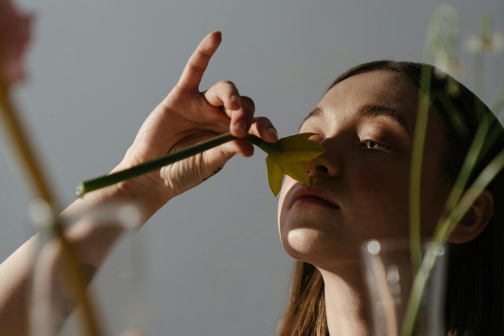 woman smelling a flower