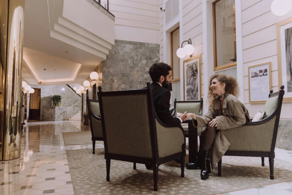 two people sitting in a hottel lobby
