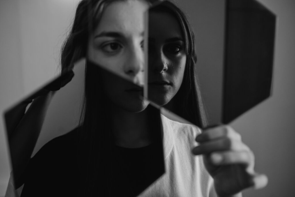 young woman holding a mirror