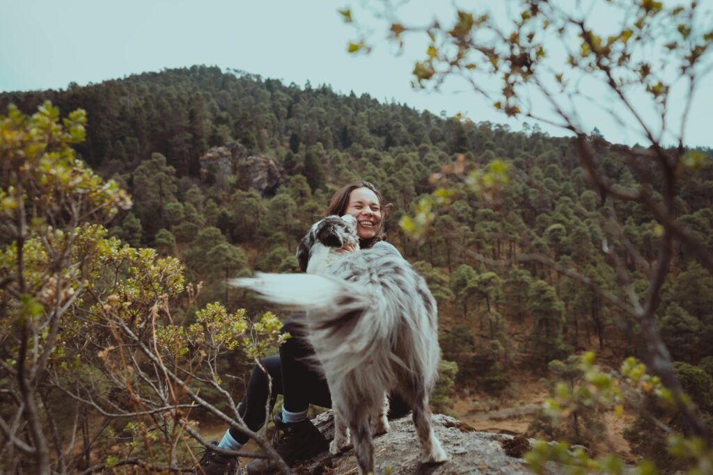 woman and dog on mountain