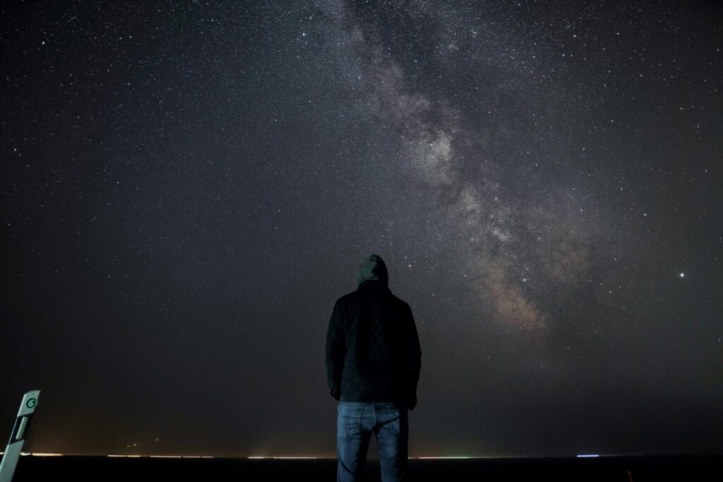 man looking at night sky