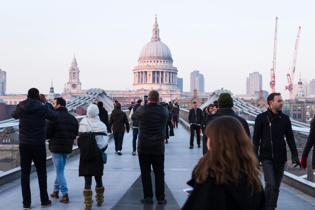 People Walking on Concrete Walkway Near Dome
